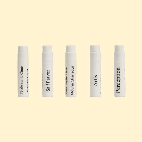 A studio product photograph showing five white perfume sample spray vials arranged in a horizontal row against a soft cream background. Each vial is labeled with a fragrance name from the Centifolia Impressionnée collection, including Pétale sur la Cime, Grace, Caprifoglio Nero, Artis, and Perception. The minimalist vials feature black typography and are evenly spaced, highlighting the discovery set format.