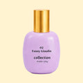 A studio product photograph of a rounded lavender-purple perfume bottle with a reflective gold cylindrical cap, set against a soft cream background. Black text on the bottle reads “02 Fanny Ginolin” and “collection ·trente cinq·”. The glossy bottle surface reflects the surrounding light, emphasising its smooth, sculptural form.