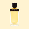 Belle de Jour by ERIS Parfums in a clear glass perfume bottle with pale golden fragrance, black label and black cap against a cream background.