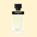 ERIS Parfums Green Spell eau de parfum in a clear rectangular glass bottle with pale green fragrance, black label and black cap, photographed against a soft cream background.