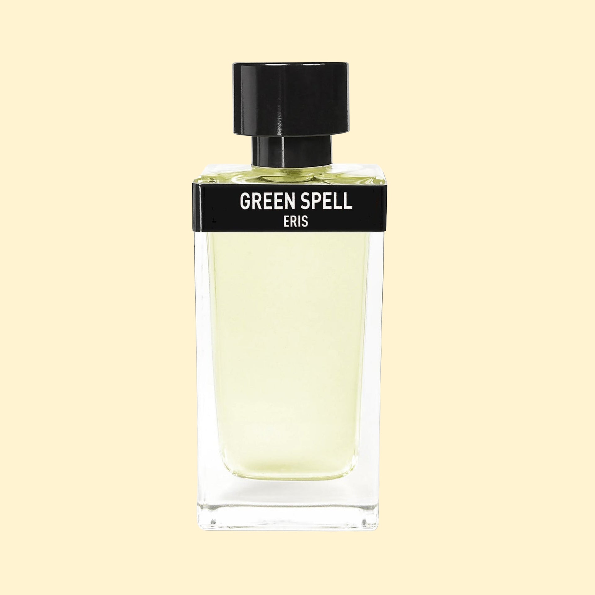 ERIS Parfums Green Spell eau de parfum in a clear rectangular glass bottle with pale green fragrance, black label and black cap, photographed against a soft cream background.