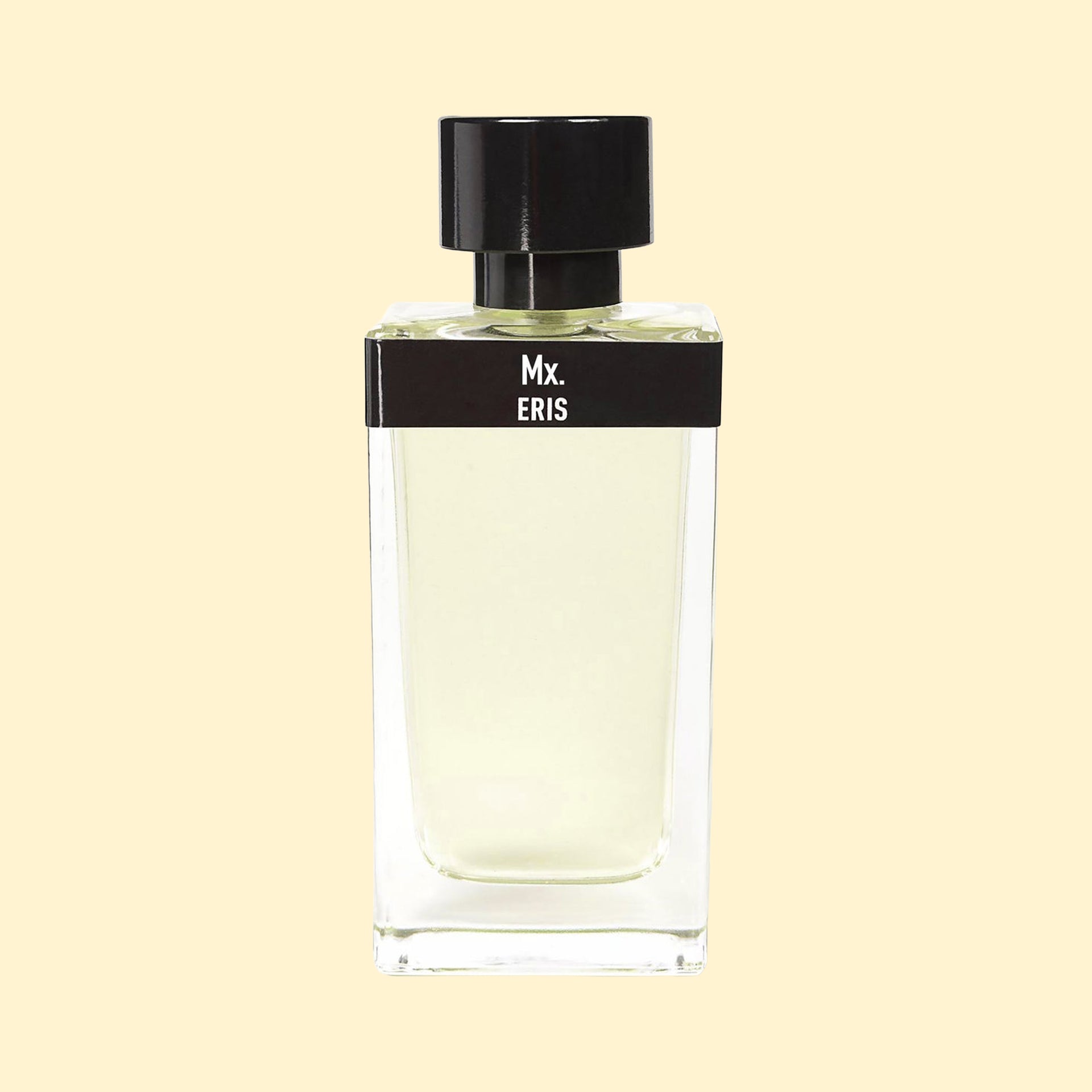 Mx. by ERIS Parfums in a clear glass perfume bottle with pale green fragrance, black label and black cap against a cream background.