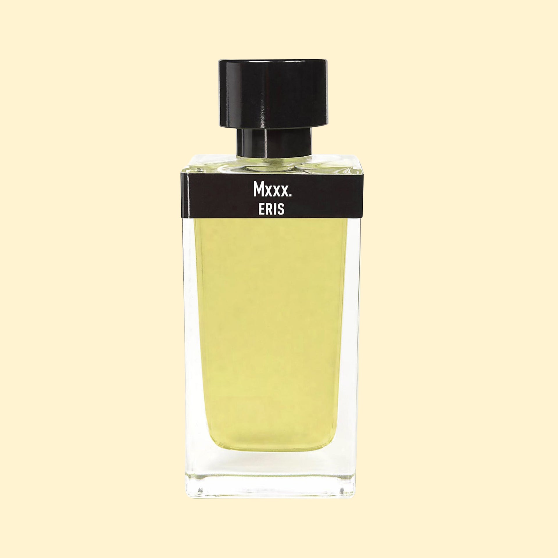 ERIS Parfums Mxxx. eau de parfum in a clear rectangular glass bottle with pale yellow-green fragrance, black label and black cap, photographed against a soft cream background.