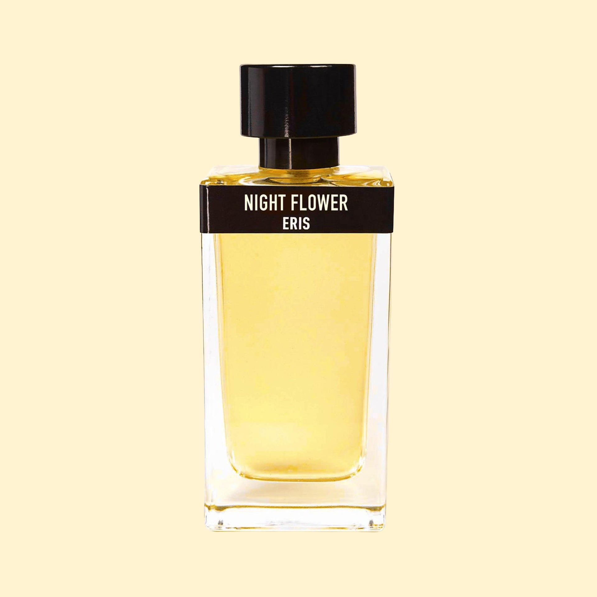 Night Flower by ERIS Parfums in a clear glass perfume bottle with pale golden fragrance, black label and black cap against a cream background.