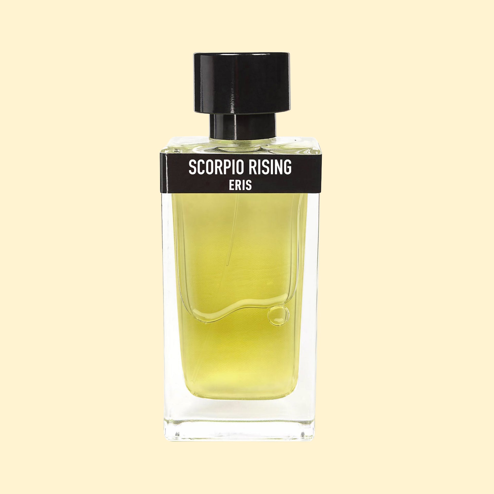 Scorpio Rising by ERIS Parfums in a clear glass perfume bottle with yellow-green fragrance, black label and black cap against a cream background.