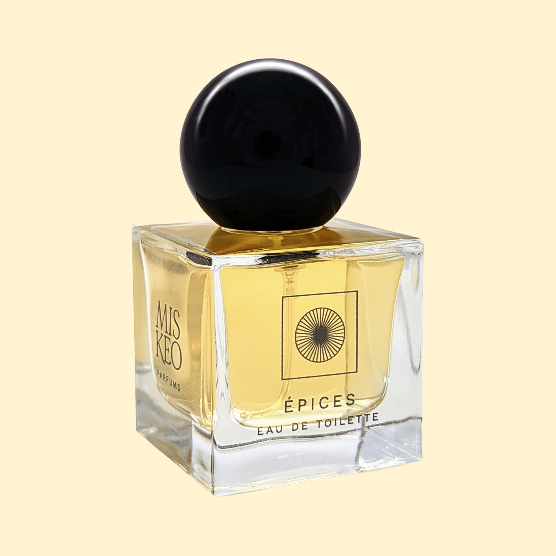 MISKEO Parfums Épices Eau de Toilette-flesje met een glanzende zwarte bolvormige dop en een lichtgouden geur.