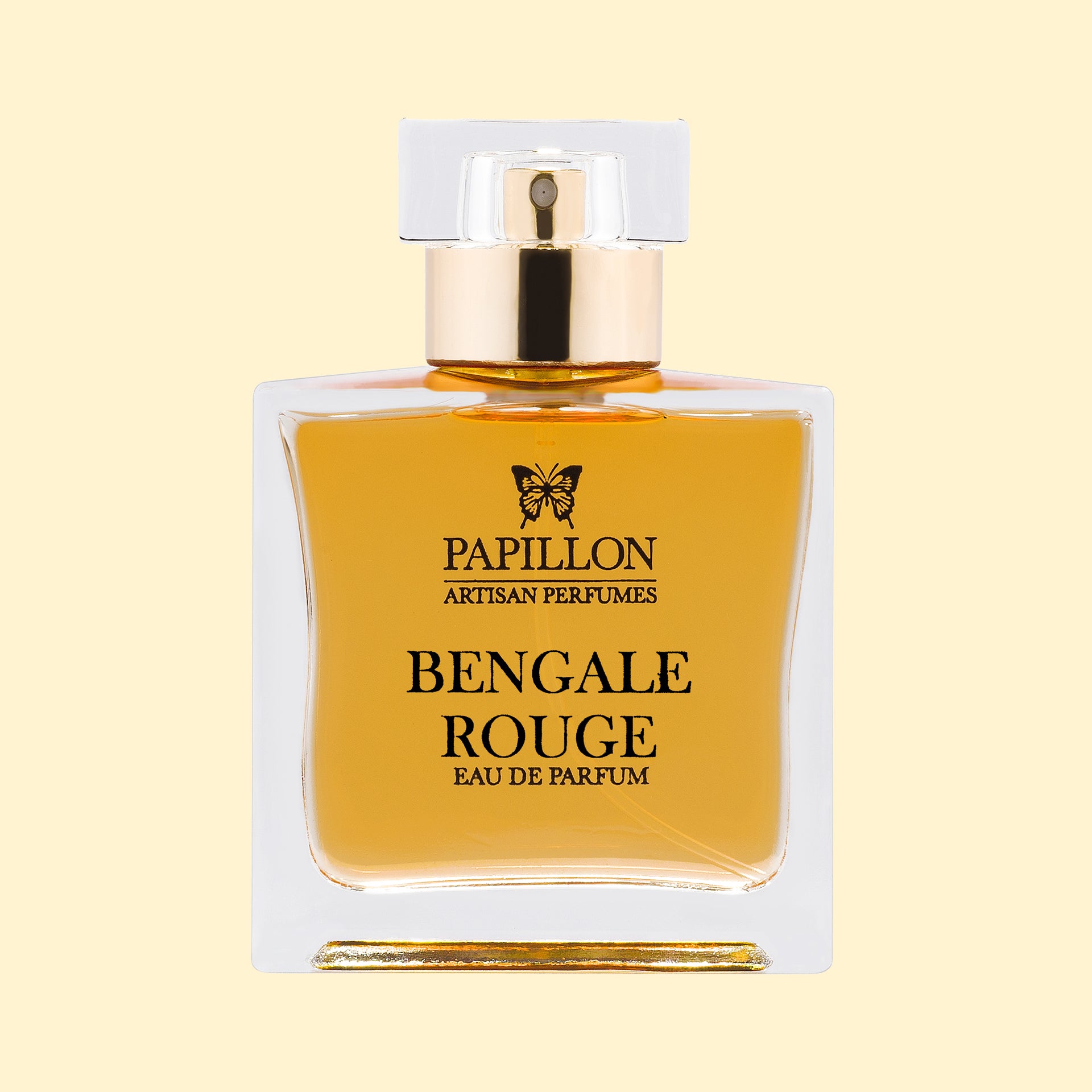 Papillon Artisan Perfumes Bengale Rouge Eau de Parfum in a clear rectangular glass bottle with a white cap and gold collar, filled with warm golden-amber fragrance against a soft cream background.