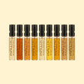 Papillon Discovery Set met negen parfumstalen van Papillon Artisan Perfumes in glazen sprayflacons, gevuld met geuren uit de volledige collectie en gepresenteerd tegen een zachte crèmekleurige achtergrond.