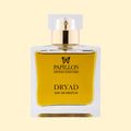 Papillon Artisan Perfumes Dryad Eau de Parfum in a clear rectangular glass bottle with a white cap and gold collar, filled with rich golden-yellow fragrance against a soft cream background.