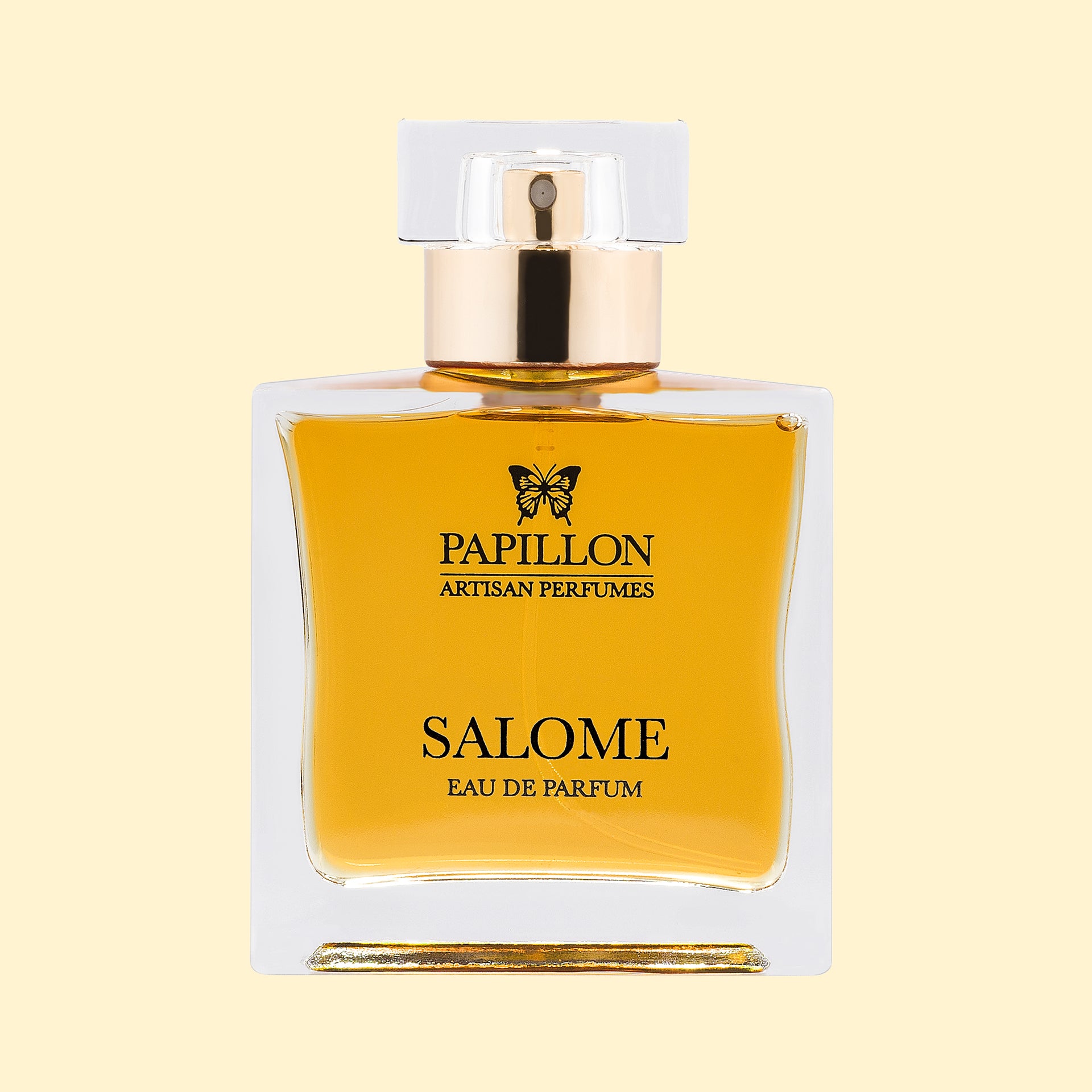 Papillon Artisan Perfumes Salome Eau de Parfum in a clear rectangular glass bottle with a white cap and gold collar, filled with warm golden-amber fragrance against a soft cream background.