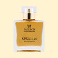 Papillon Artisan Perfumes Spell 125 Eau de Parfum in a clear rectangular glass bottle with a white cap and gold collar, filled with soft amber-gold fragrance against a soft cream background.
