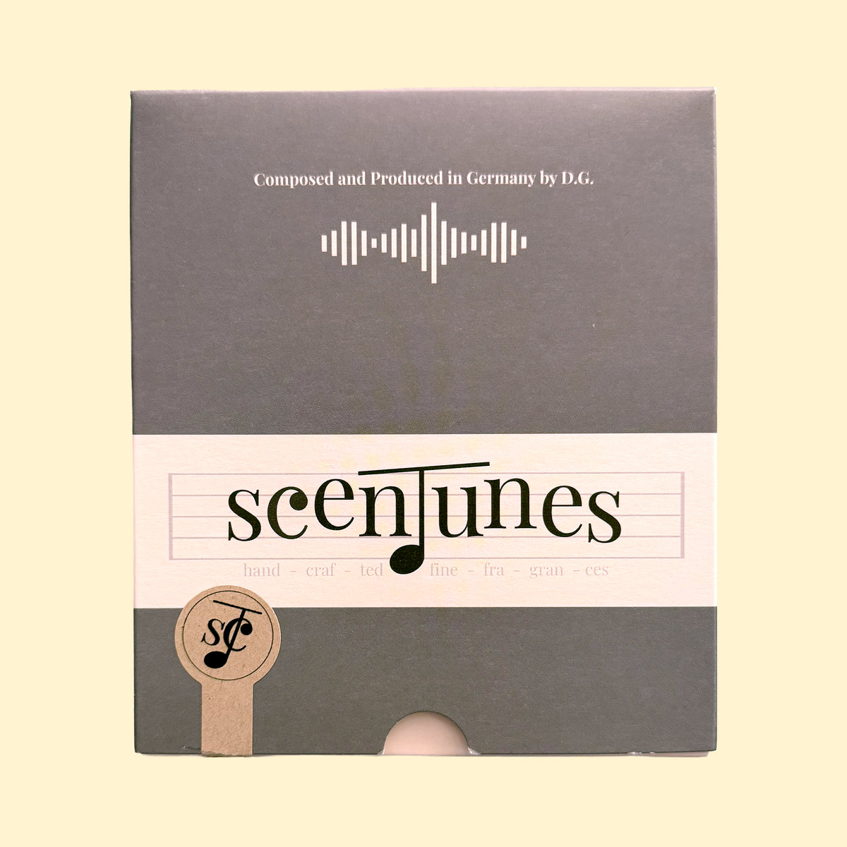 Grijze verpakking van scenTunes Discovery Set I met crèmekleurige band en muzikaal logo.